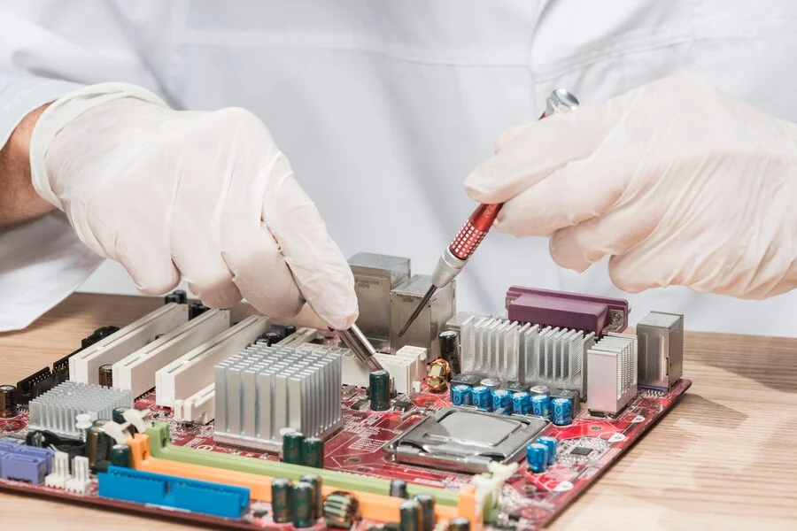 Certified technician repairing TV motherboard